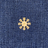 Gold snowflake patch on blue denim fabric