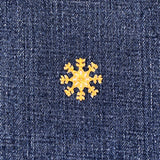 Gold snowflake patch on a denim background
