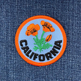Embroidered patch with California poppies on denim fabric