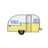 Embroidered retro-style travel trailer patch in yellow, white, black, and gray with a small red accent, shown on a plain white background.