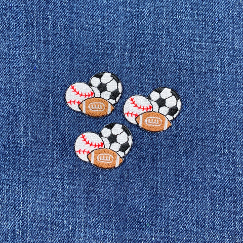 three sports patches each depicting a baseball, football, and soccer ball on a denim background