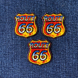 Three Route 66 patches on a denim background