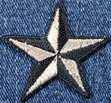 Embroidered star patch on denim fabric