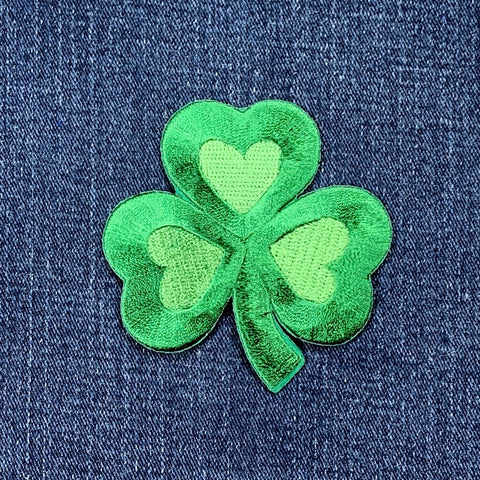Green 3 inch shamrock patch on denim fabric