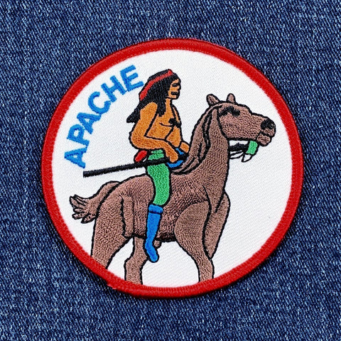 Patch of a Native American rider on a horse with 'Apache' text on a denim background