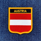 Embroidered patch with Austrian flag design on a denim background