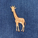 Embroidered giraffe patch on denim fabric