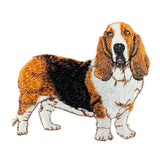 An embroidered basset hound patch in brown, white, and black, placed on a white background.