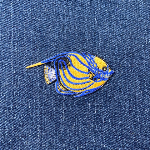 Fish-shaped patch on a denim background