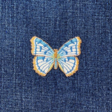 Blue butterfly patch on denim fabric