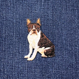 Embroidered patch of a bull terrier dog on denim fabric