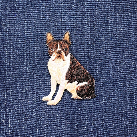 Embroidered patch of a bull terrier dog on denim fabric