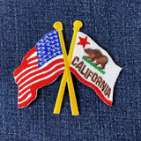 Embroidered patch with American and California flags on denim fabric