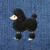 Black poodle patch on blue denim fabric