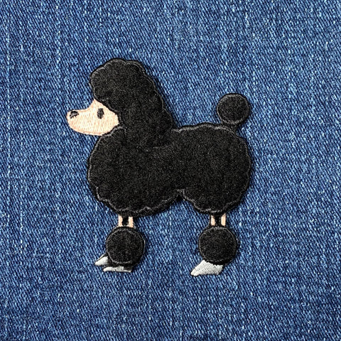 Black poodle patch on blue denim fabric