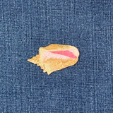 Embroidered seashell patch on denim fabric