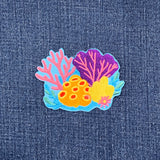 Colorful coral patch on denim fabric