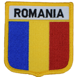 A shield-shaped embroidered patch with the text ROMANIA and the flag colors blue, yellow, and red.