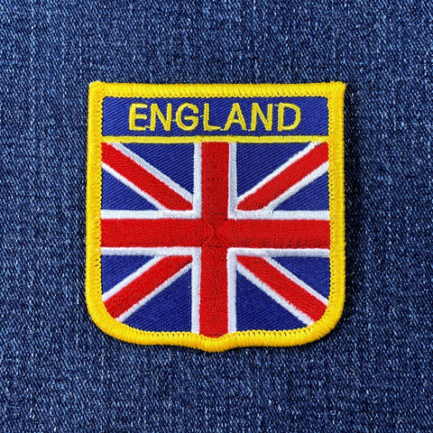 An embroidered badge featuring the Union Jack flag with the text 'ENGLAND' at the top, displayed on a denim background