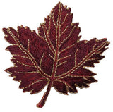 Embroidered burgundy maple leaf on a white background