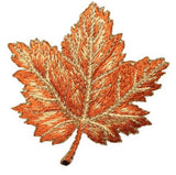 Embroidered tan maple leaf on a white background