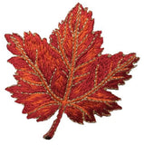 Embroidered orange leaf patch on a white background