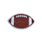 A football-shaped patch with a glittery bronze-brown center, white side panels, white laces, and a silver embroidered border, shown on a plain white background.