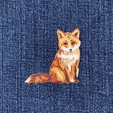 Embroidered fox patch on denim fabric