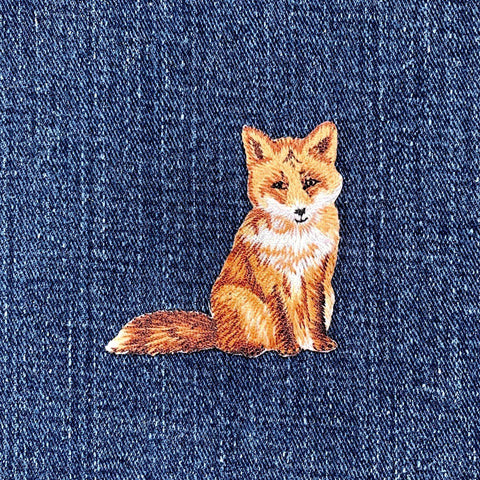 Embroidered fox patch on denim fabric