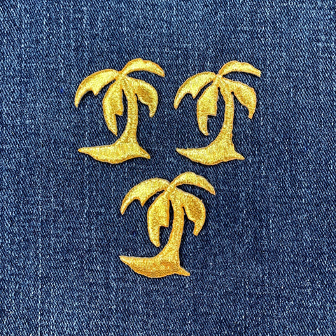 Gold palm tree patches on a blue denim background