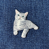 Embroidered cat patch on denim fabric