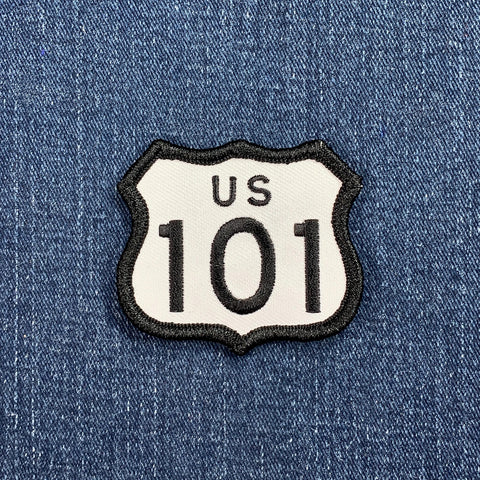 A shield-shaped patch with 'US 101' text displayed on a denim background