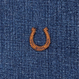 A brown embroidered horseshoe applique patch displayed on a denim background
