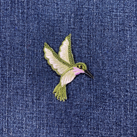 hummingbird patch with lavender accent on a denim background