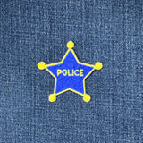 Blue star-shaped police badge patch on denim fabric