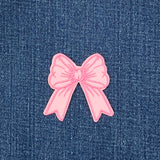 Pink bow patch on a denim background