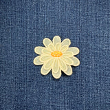 pale yellow layered daisy patch on a denim background