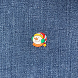 Embroidered snowman patch on denim fabric
