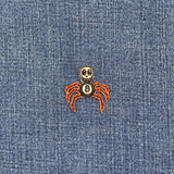Spider with a skull head patch on blue denim fabric