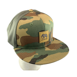 Camouflage baseball cap with a LET'S BE IRIE logo on a white background