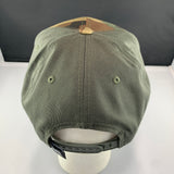 Green cap on a mannequin head with a plain background
