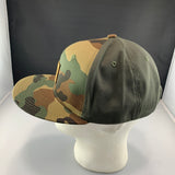 Camouflage and green baseball cap on a mannequin head against a dark background