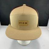 Beige cap with brown mesh and 'Let's Be Irie' patch on a black background