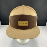 Beige and brown cap with 'Let's Be Irie' logo on a black background