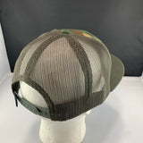 Green mesh cap on a mannequin head with a dark background