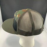 Camouflage mesh cap on a mannequin head with a dark background