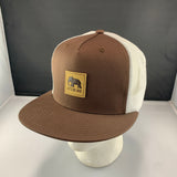 Brown and white cap with a 'Let's Be Irie' patch on a black background
