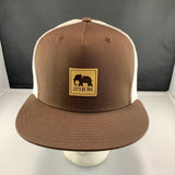 Brown and white cap with a 'Let's Be Irie' patch on a black background