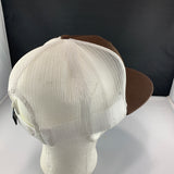 Brown and beige cap on a mannequin head with a plain background