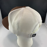 Brown and white cap with a 'Let's Be Irie' tag on a black background